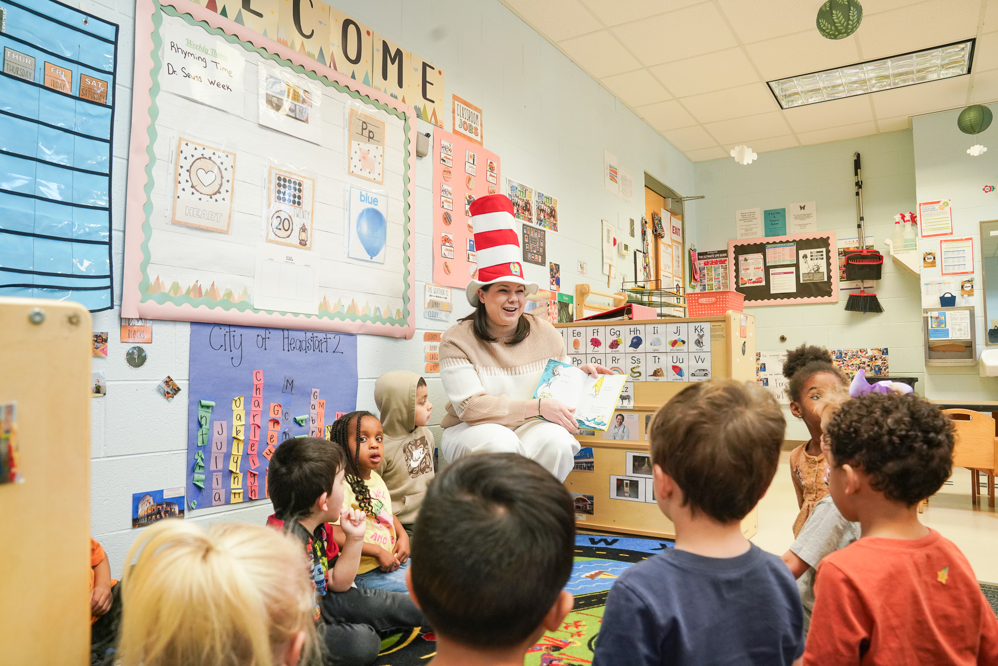 Volunteer reading to a group of children.